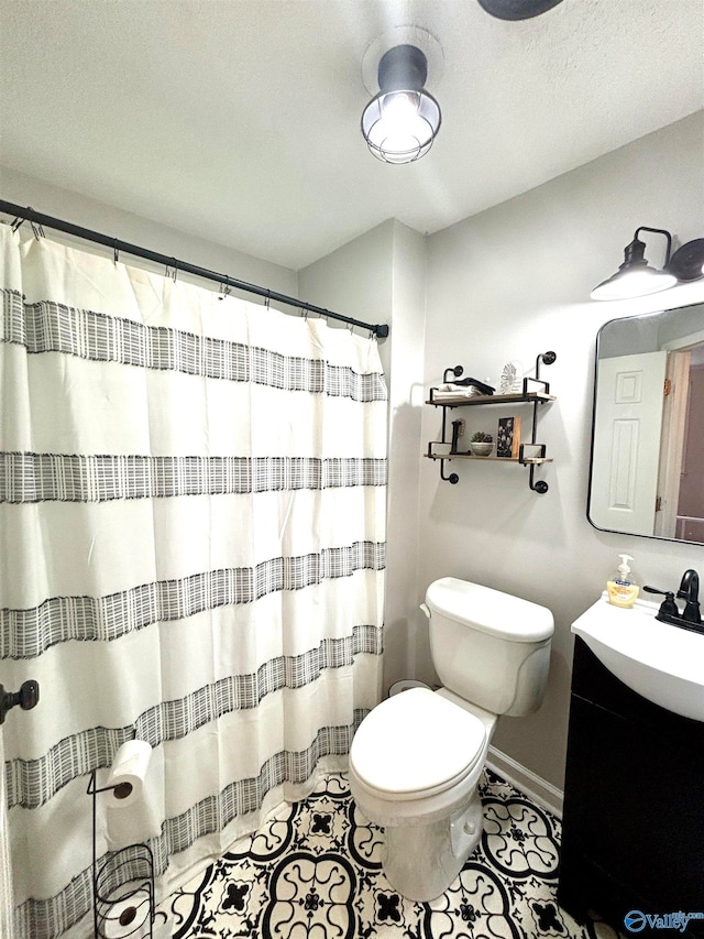 bathroom featuring vanity, toilet, and tile patterned floors