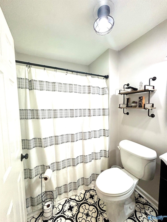 bathroom with tile patterned floors, toilet, and vanity