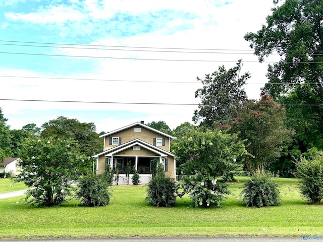 view of front of property with covered porch and a front lawn