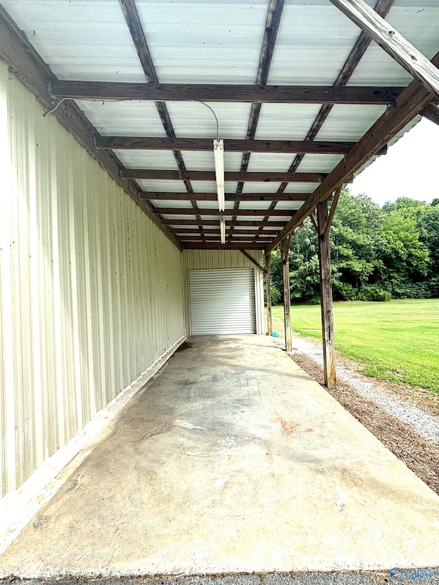 garage featuring a yard and a carport