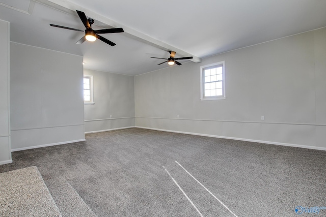 carpeted empty room featuring vaulted ceiling with beams and ceiling fan