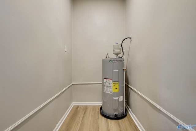 utility room featuring electric water heater