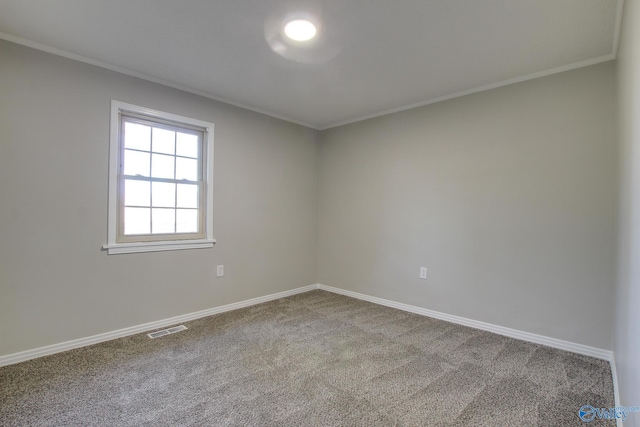 carpeted empty room featuring crown molding