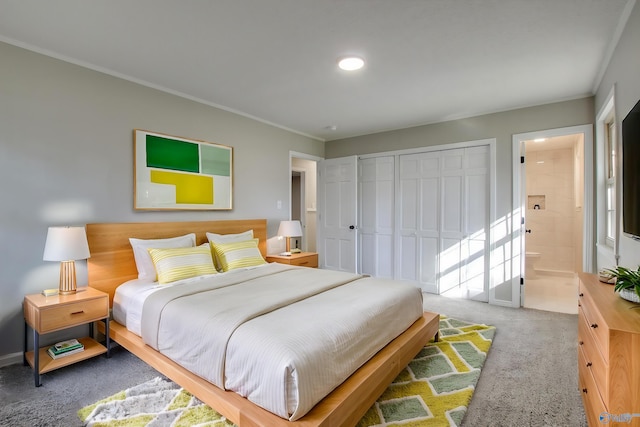 bedroom featuring ornamental molding, carpet flooring, ensuite bathroom, and a closet