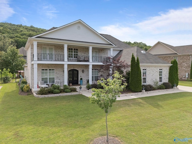 11 SE Braewick Pl, Gurley, AL 35748 - neoclassical home with a balcony, covered porch, a front lawn, and brick siding
