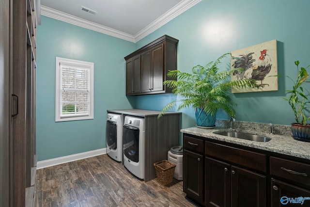 11 SE Braewick Pl, Gurley, AL 35748 - laundry area featuring washer and clothes dryer, crown molding, dark wood finished floors, cabinet space, and baseboards