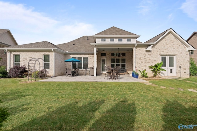 11 SE Braewick Pl, Gurley, AL 35748 - rear view of house featuring brick siding, a patio area, a lawn, and roof with shingles