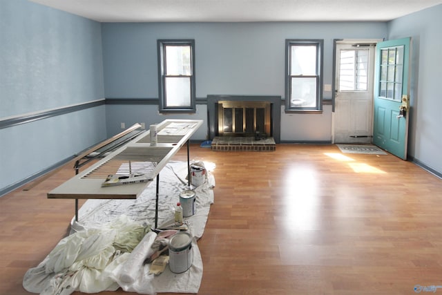 interior space featuring a fireplace, baseboards, and wood finished floors