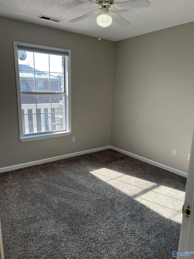 carpeted empty room featuring a textured ceiling and ceiling fan