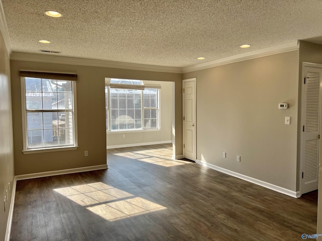 unfurnished room with dark hardwood / wood-style flooring, a textured ceiling, and plenty of natural light