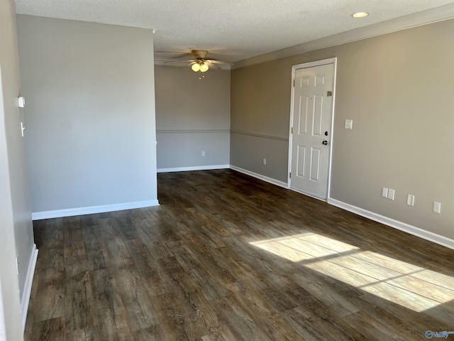 spare room featuring ceiling fan, dark wood-type flooring, a textured ceiling, and ornamental molding