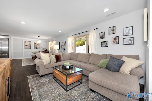 living room featuring recessed lighting, dark wood-style flooring, and visible vents