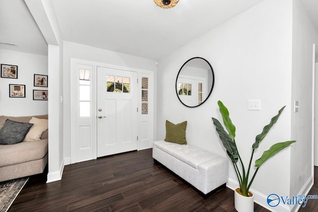 entryway featuring dark wood-type flooring and baseboards