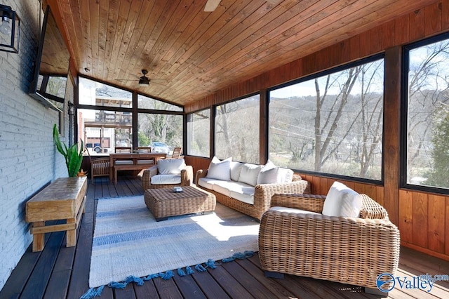 sunroom / solarium with vaulted ceiling, wooden ceiling, and a ceiling fan