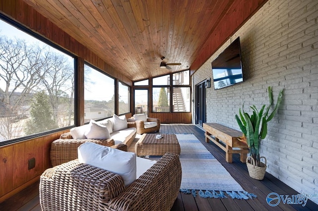 sunroom / solarium featuring a ceiling fan, lofted ceiling, and wooden ceiling