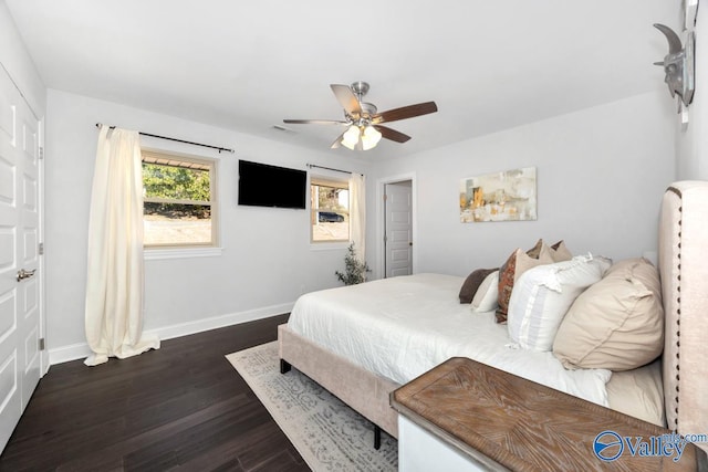 bedroom featuring ceiling fan, dark wood-type flooring, visible vents, and baseboards