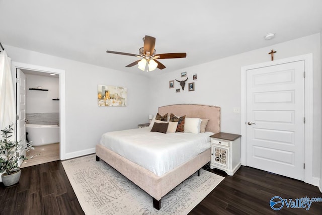 bedroom with dark wood-style floors, ensuite bath, baseboards, and a ceiling fan