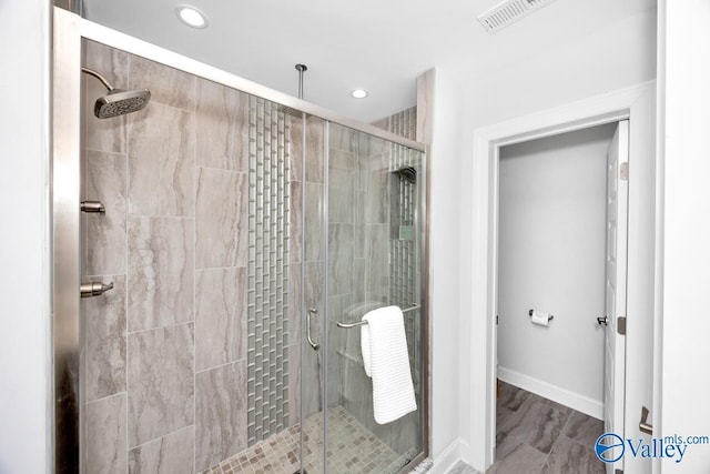 bathroom featuring recessed lighting, visible vents, a shower stall, and baseboards