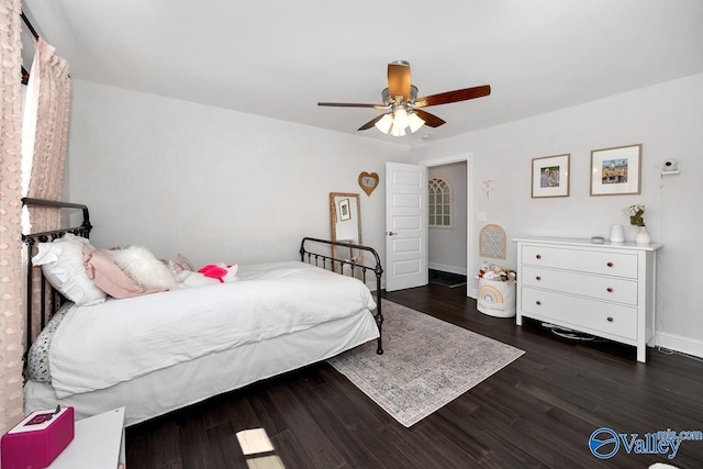 bedroom with baseboards, a ceiling fan, and wood finished floors