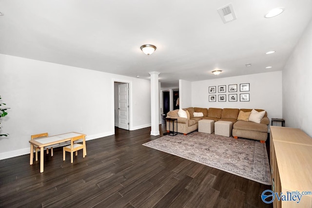 living room with recessed lighting, visible vents, baseboards, dark wood finished floors, and decorative columns