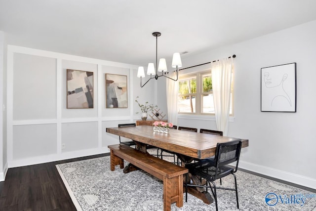 dining area with an inviting chandelier, baseboards, and dark wood-style flooring