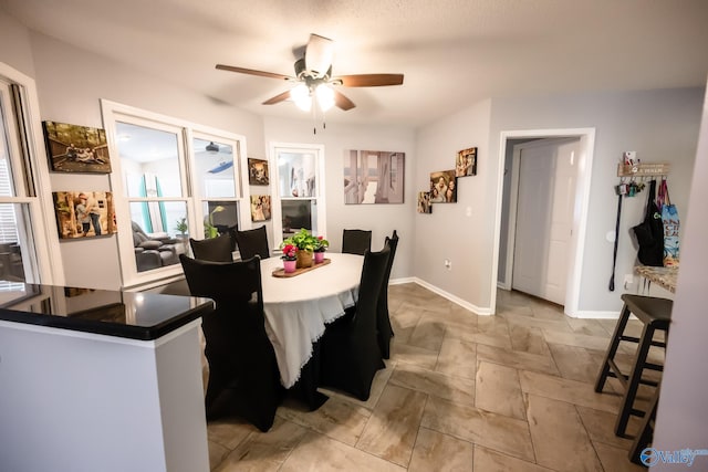 dining room featuring baseboards and a ceiling fan