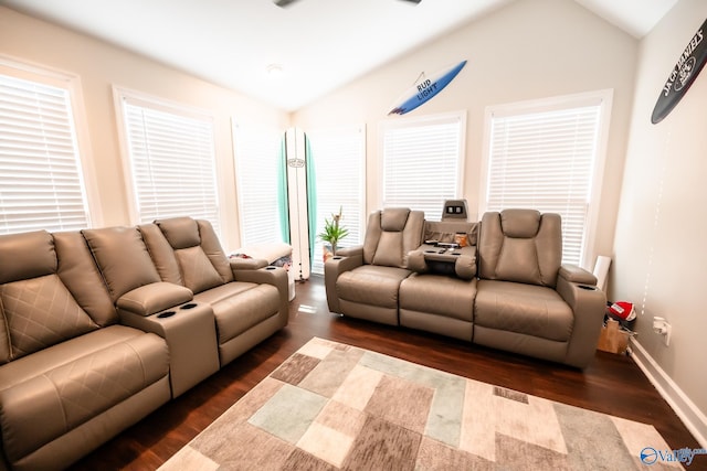 living room with lofted ceiling, dark wood-type flooring, and baseboards