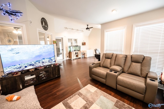 living room with a ceiling fan, dark wood-style flooring, and vaulted ceiling