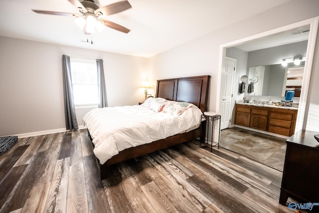 bedroom featuring visible vents, ceiling fan, ensuite bath, and dark wood-style floors