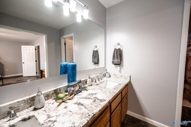 bathroom featuring vanity and baseboards