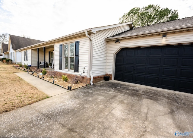 view of property exterior with a lawn and concrete driveway