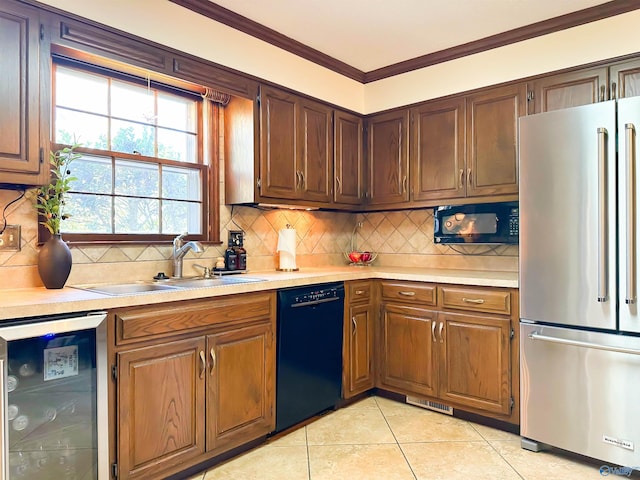 kitchen with light countertops, a sink, freestanding refrigerator, dishwasher, and ornamental molding