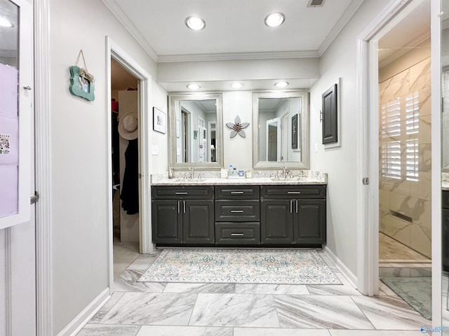 full bathroom featuring double vanity, ornamental molding, a sink, and baseboards