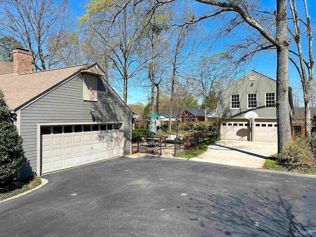 exterior space featuring a chimney and a garage