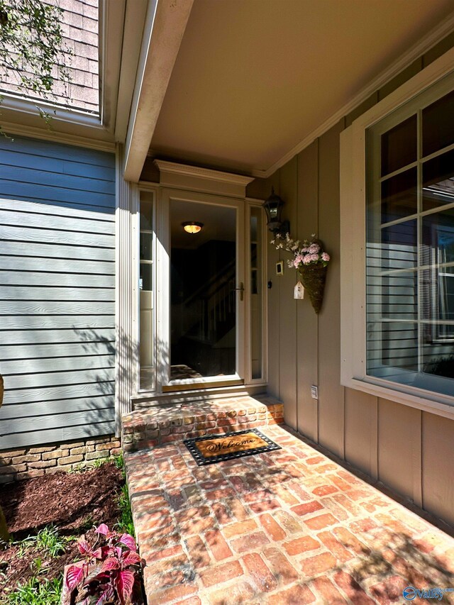property entrance featuring board and batten siding