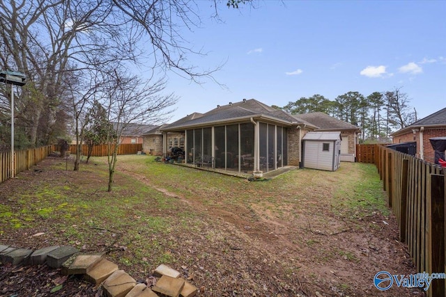 rear view of property featuring a storage unit and a sunroom