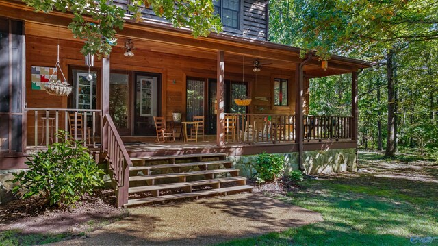 view of side of property featuring a yard and covered porch