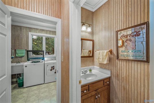 bathroom with crown molding, washing machine and dryer, vanity, and tile patterned flooring