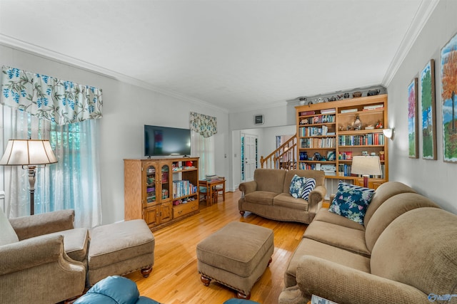 living room with ornamental molding, plenty of natural light, and hardwood / wood-style flooring