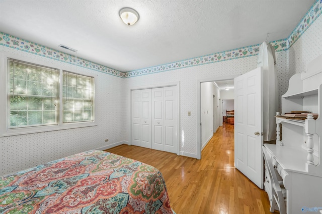 251 Wells St, Mentone, AL 35984 - bedroom featuring a closet, visible vents, wallpapered walls, and light wood-style flooring