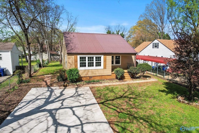 rear view of property with crawl space, a yard, metal roof, and fence