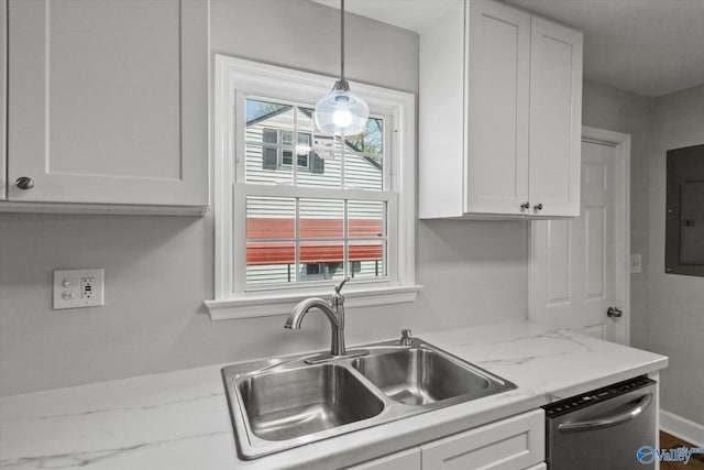 kitchen with a sink, stainless steel dishwasher, white cabinetry, and a wealth of natural light
