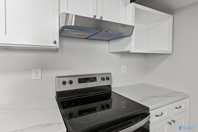 kitchen featuring under cabinet range hood, light stone counters, white cabinets, and stainless steel electric range