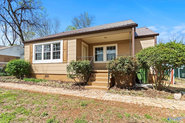 view of front facade featuring metal roof, covered porch, and crawl space