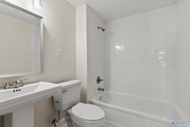 bathroom featuring a sink, toilet, and shower / washtub combination