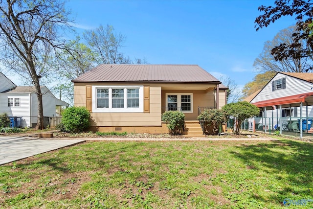 bungalow with crawl space, metal roof, a front yard, and fence