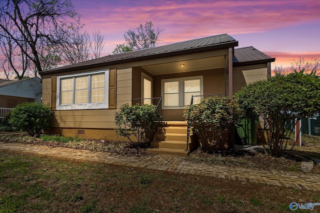 view of front of home featuring metal roof, covered porch, and crawl space