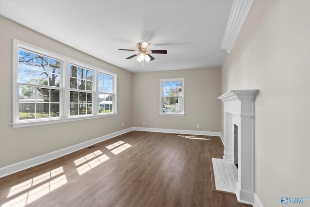 unfurnished living room with a fireplace, dark wood finished floors, a ceiling fan, visible vents, and baseboards