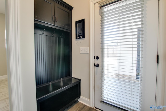 mudroom featuring wood finished floors and baseboards