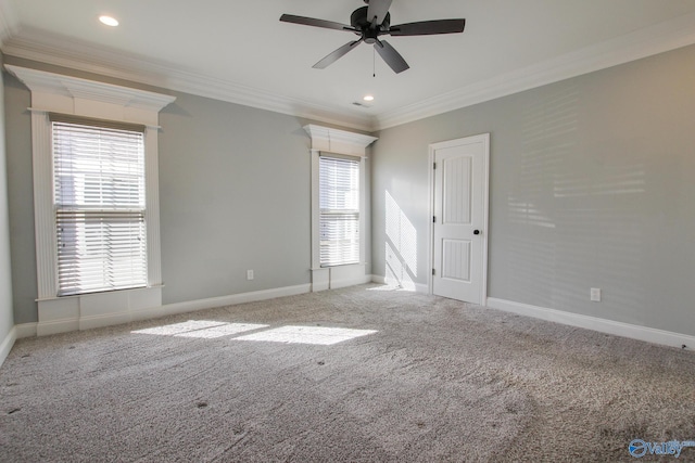 unfurnished room with a healthy amount of sunlight, carpet, and crown molding